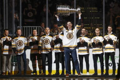 Mar 7, 2024; Boston, Massachusetts, USA; In ceremonies honoring the 100th season of the Boston Bruins, former captain Zdeno Chara raises the Stanley Cup as teammates from their 2011 championship team look on before the game between the Boston Bruins and the Toronto Maple Leafs at TD Garden. Mandatory Credit: Winslow Townson-USA TODAY Sports