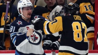 Nov 22, 2024; Pittsburgh, Pennsylvania, USA; Winnipeg Jets left wing Kyle Connor (81) and Pittsburgh Penguins center Sidney Crosby (87) fight during the second period at PPG Paints Arena. Mandatory Credit: Charles LeClaire-Imagn Images