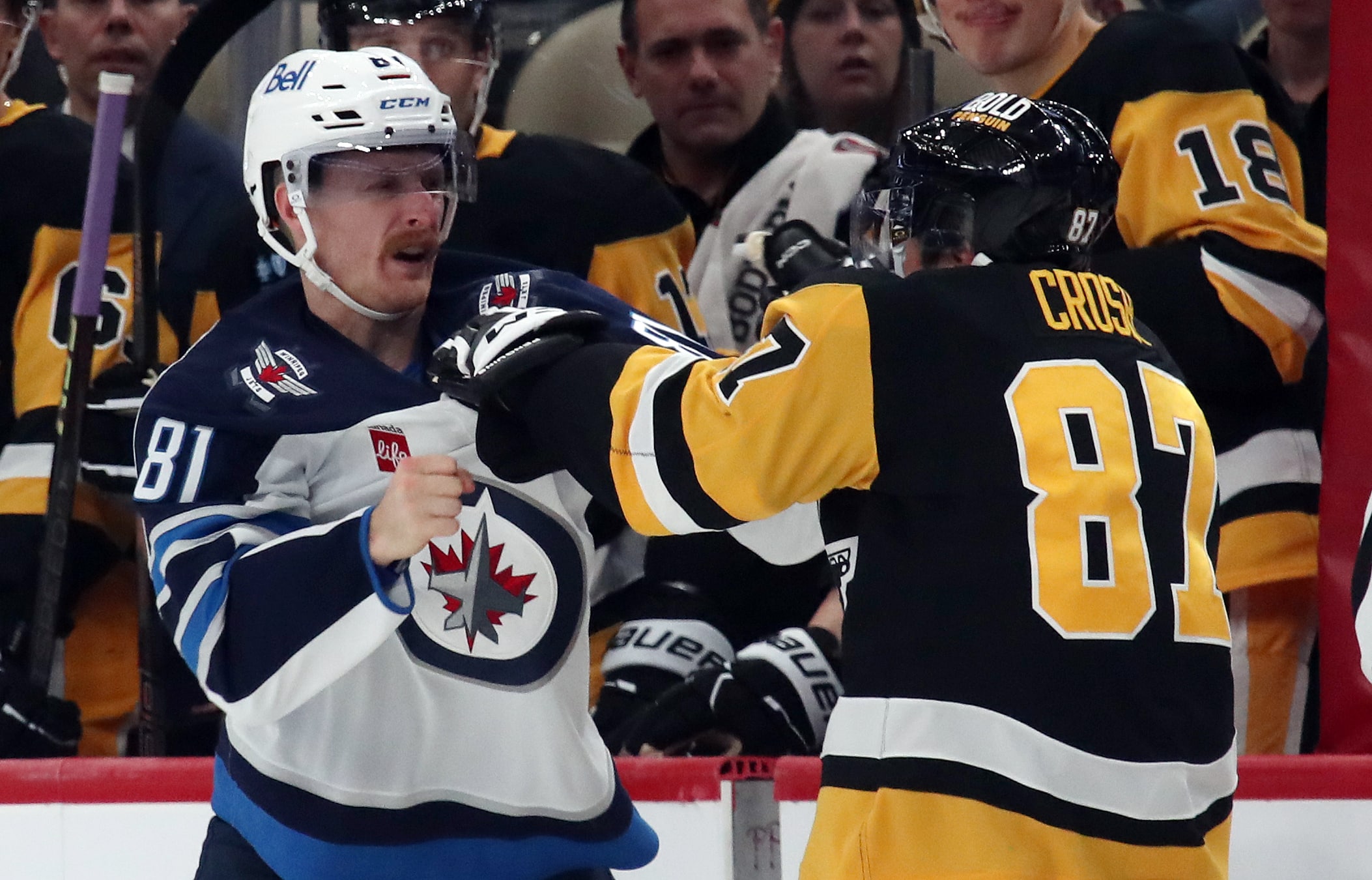 Nov 22, 2024; Pittsburgh, Pennsylvania, USA; Winnipeg Jets left wing Kyle Connor (81) and Pittsburgh Penguins center Sidney Crosby (87) fight during the second period at PPG Paints Arena. Mandatory Credit: Charles LeClaire-Imagn Images
