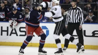 Dec 14, 2024; New York, New York, USA;  New York Rangers defenseman Connor Mackey (14) and Los Angeles Kings center Samuel Helenius in the first period at Madison Square Garden. Mandatory Credit: Wendell Cruz-Imagn Images