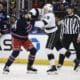 Dec 14, 2024; New York, New York, USA;  New York Rangers defenseman Connor Mackey (14) and Los Angeles Kings center Samuel Helenius in the first period at Madison Square Garden. Mandatory Credit: Wendell Cruz-Imagn Images