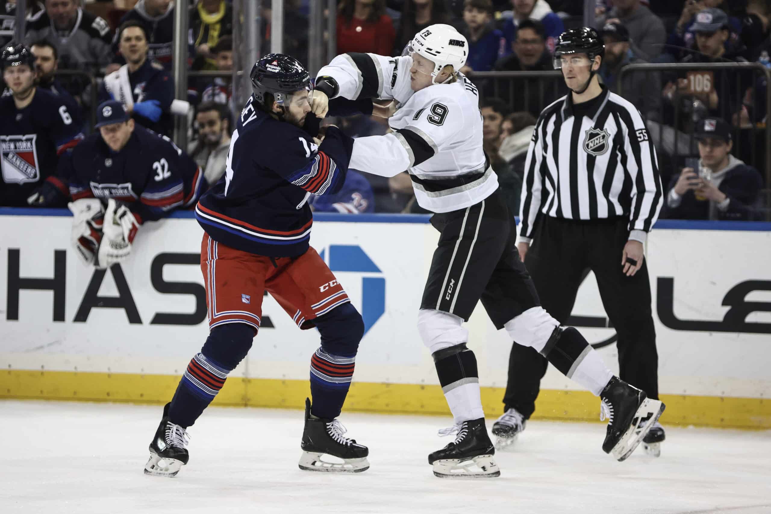 Dec 14, 2024; New York, New York, USA;  New York Rangers defenseman Connor Mackey (14) and Los Angeles Kings center Samuel Helenius in the first period at Madison Square Garden. Mandatory Credit: Wendell Cruz-Imagn Images