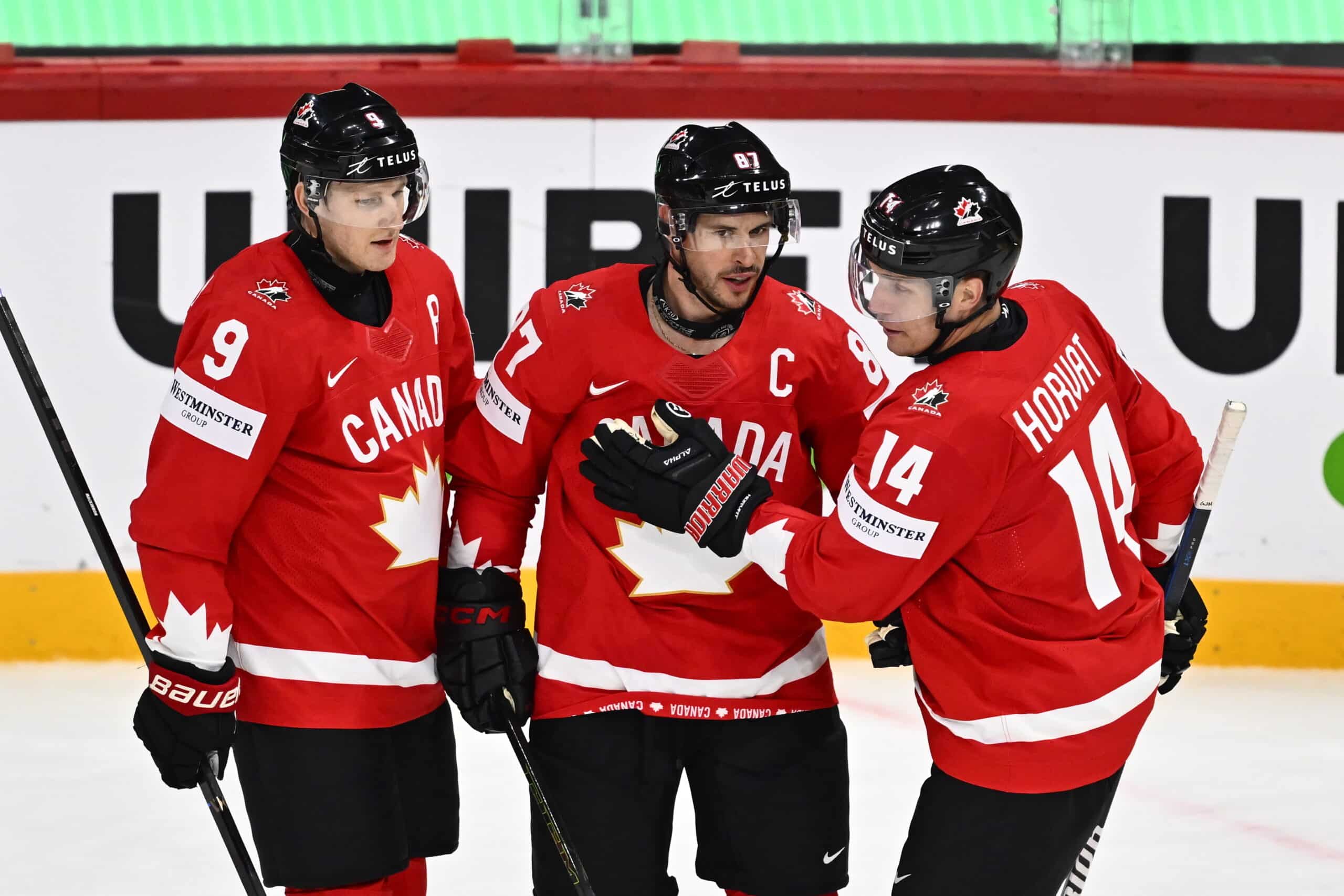 epa12097688 Canada's Sidney Crosby (C) celebrates scoring the 3-0 goal with his teammates Canada's Nate MacKinnon (L) and Bo Horvat (R) during the 2025 IIHF Ice Hockey World Championship group A match between Canada and France, in Stockholm, Sweden, 13 May 2025.  EPA-EFE/Anders Wiklund  SWEDEN OUT