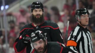 May 20, 2025; Raleigh, North Carolina, USA; Carolina Hurricanes defenseman Brent Burns (8) and forward Jordan Martinook (48) look on during the third period against the Florida Panthers in game one of the Eastern Conference Final of the 2025 Stanley Cup Playoffs at Lenovo Center. Mandatory Credit: James Guillory-Imagn Images