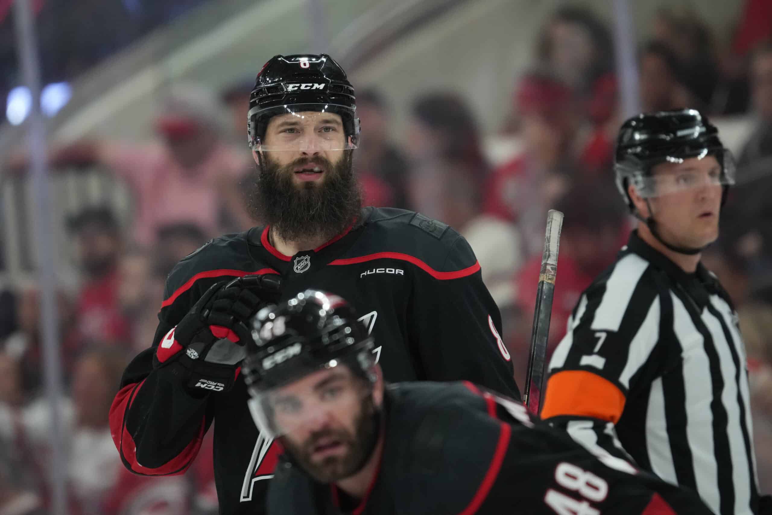 May 20, 2025; Raleigh, North Carolina, USA; Carolina Hurricanes defenseman Brent Burns (8) and forward Jordan Martinook (48) look on during the third period against the Florida Panthers in game one of the Eastern Conference Final of the 2025 Stanley Cup Playoffs at Lenovo Center. Mandatory Credit: James Guillory-Imagn Images